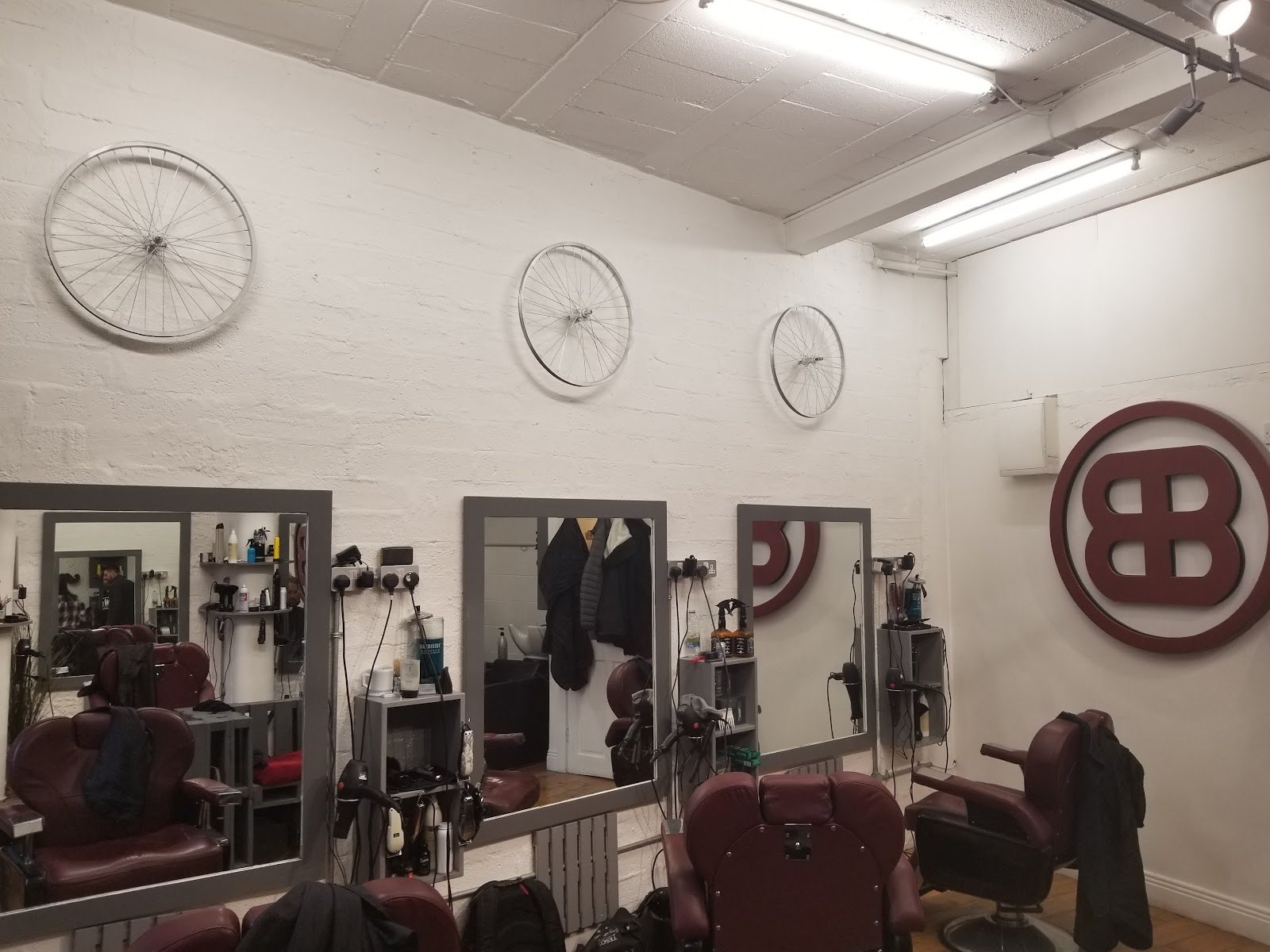 Barber chairs, mirrors and the BB mark inside Beards and Barnets, Temple Bar